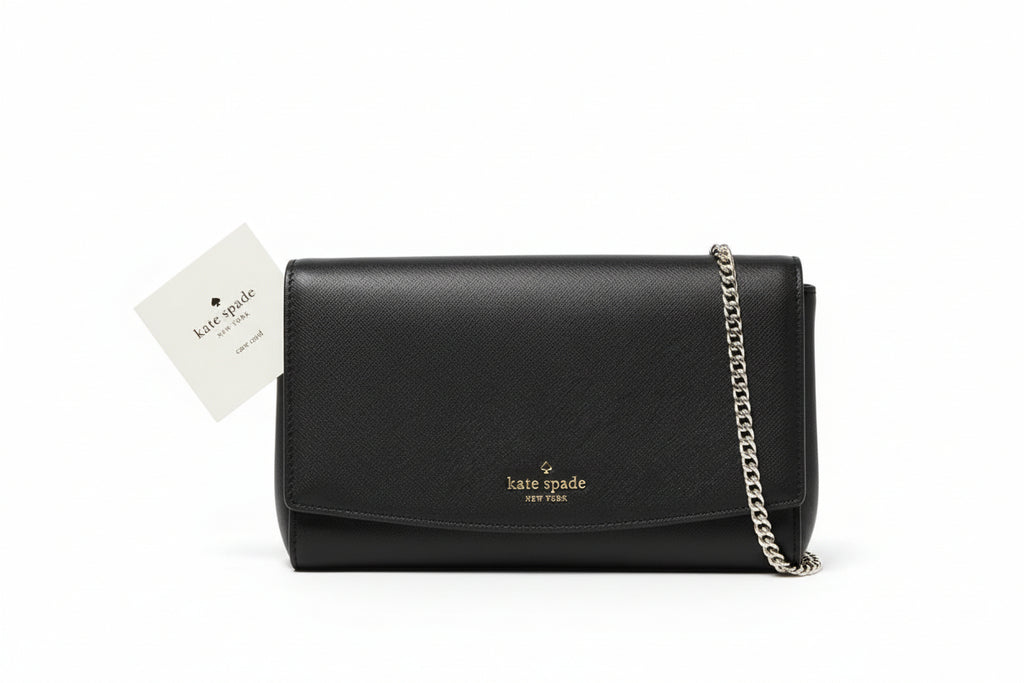 Black handbag with chain detail on a wooden surface