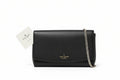 Black handbag with chain detail on a wooden surface